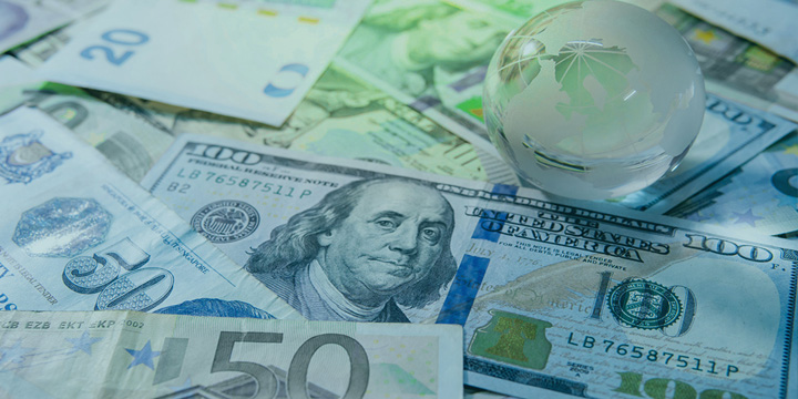 World globe crystal glass on various international money banknotes