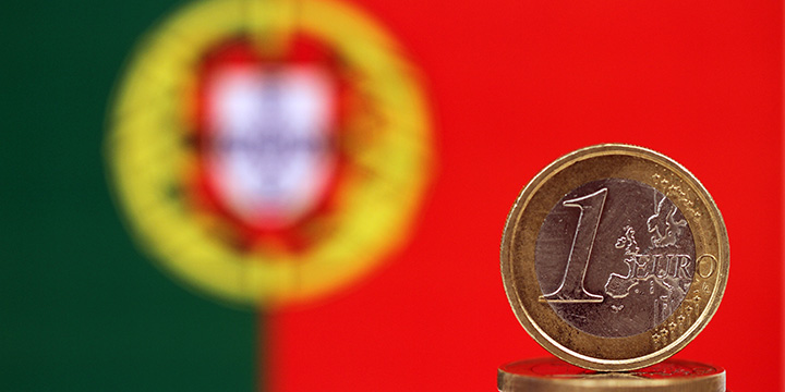 One Euro coin with Portuguese flage in the background